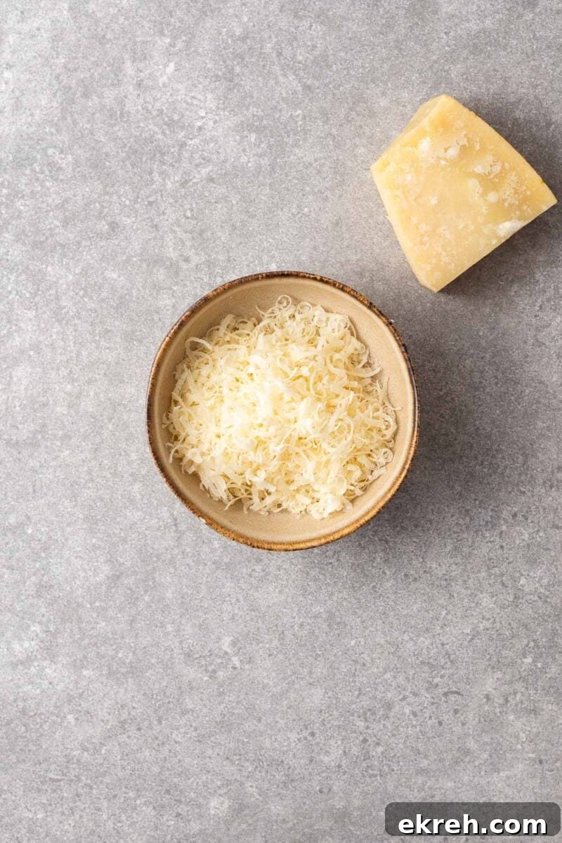 A bowl with freshly grated parmesan cheese.
