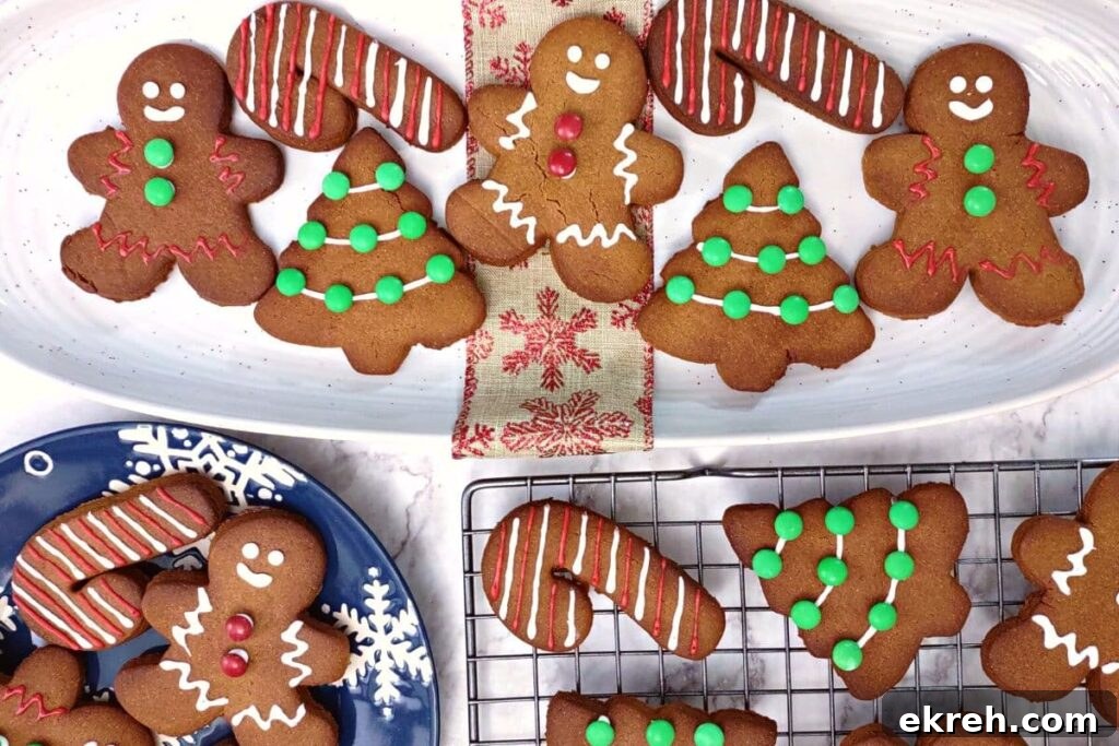 overhead view of air fryer gingerbread cookies shaped like men candy canes and christmas trees on various platters