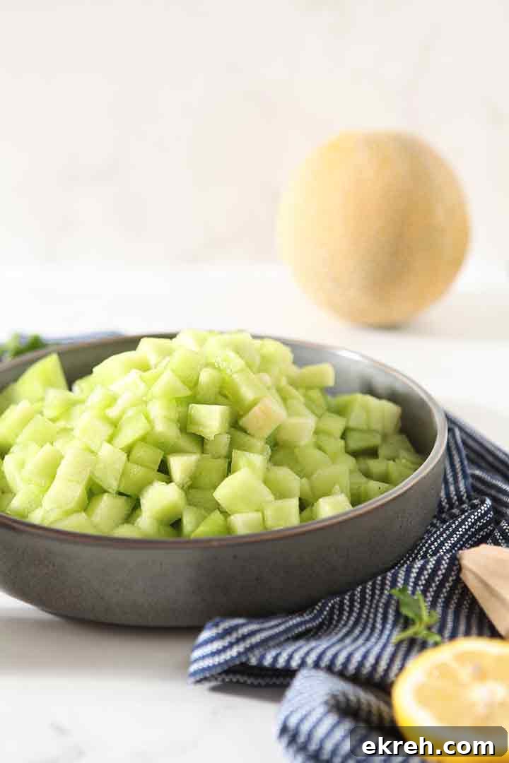 Diced melon is reserved in a bowl until it's time to mix the salad