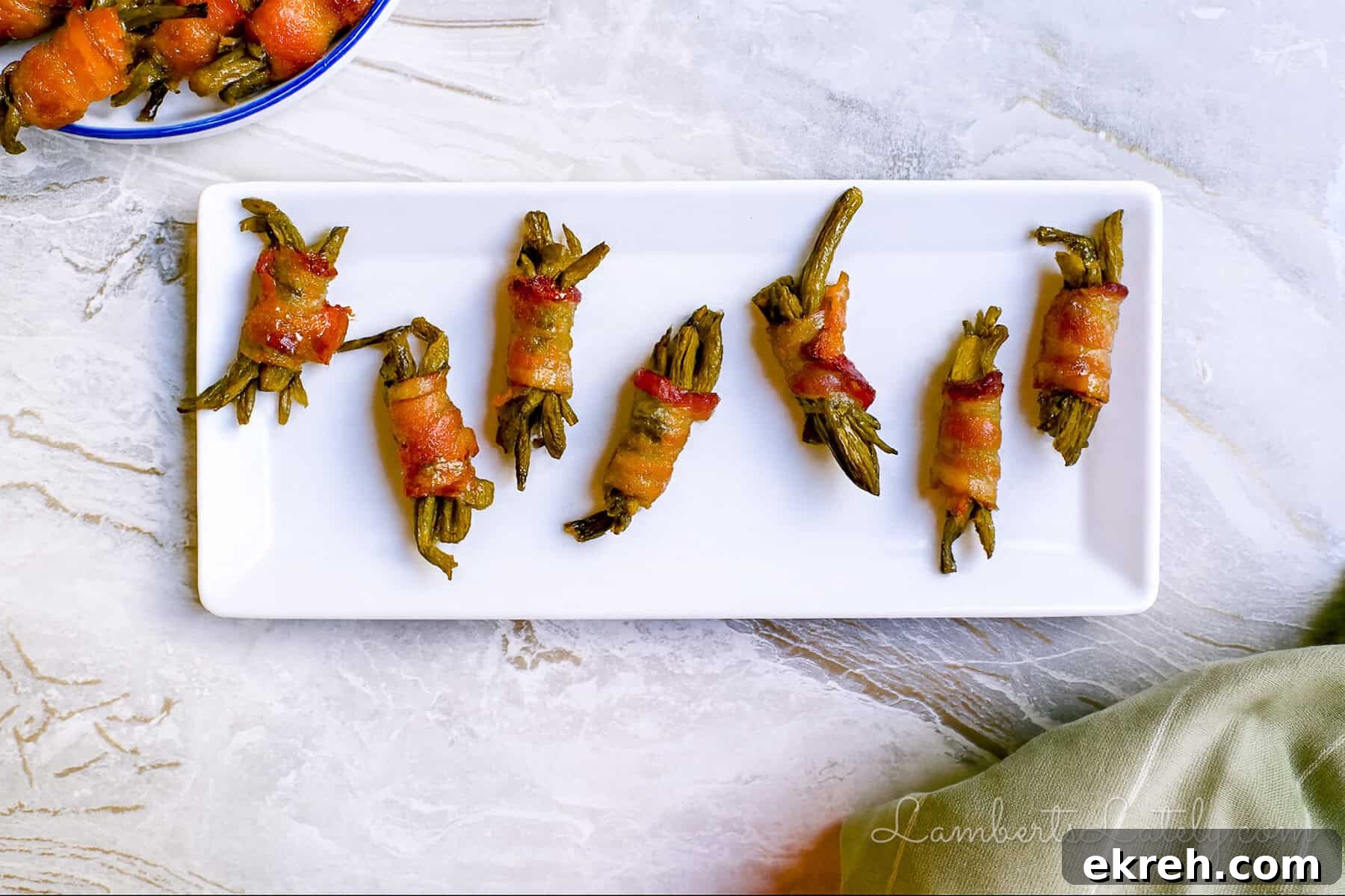 Brown Sugar Bacon Wrapped Green Bean Bundles Recipe 2 bacon wrapped green beans with brown sugar glaze on a serving platter