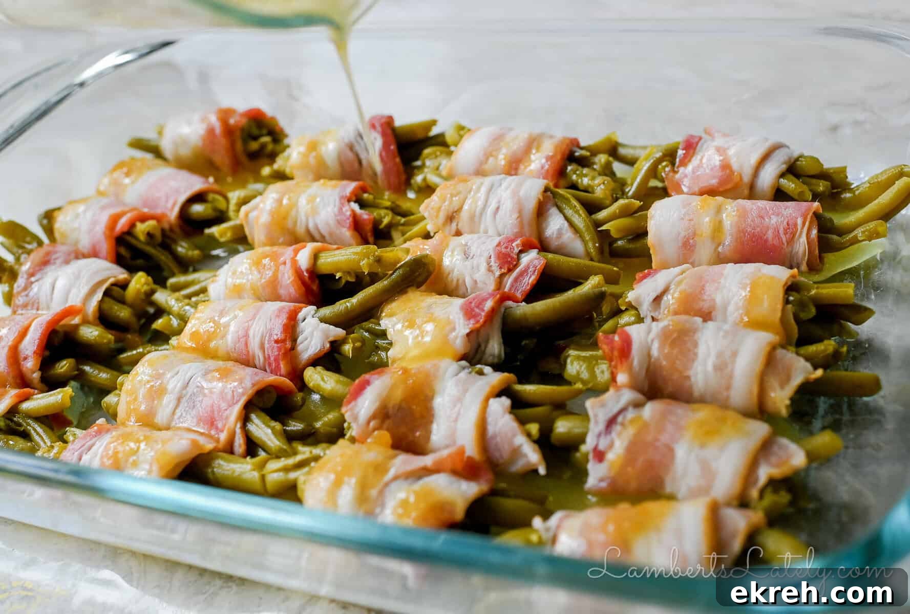 Brown Sugar Bacon Wrapped Green Bean Bundles Recipe 10 pouring brown sugar butter glaze over bacon wrapped green bean bundles.