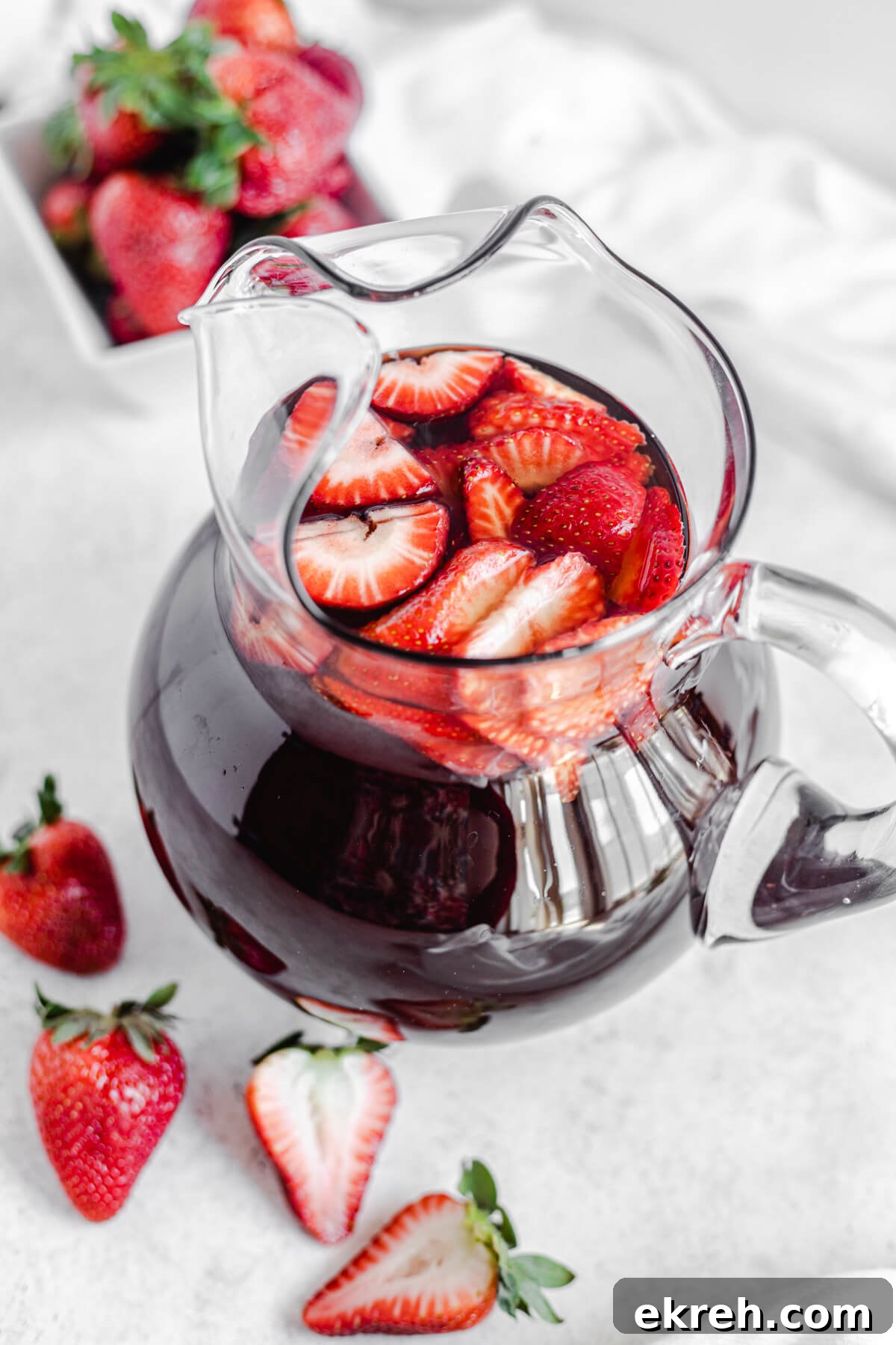 Homemade Strawberry Iced Tea Recipe 5 glass pitcher of iced tea with fresh sliced strawberries inside
