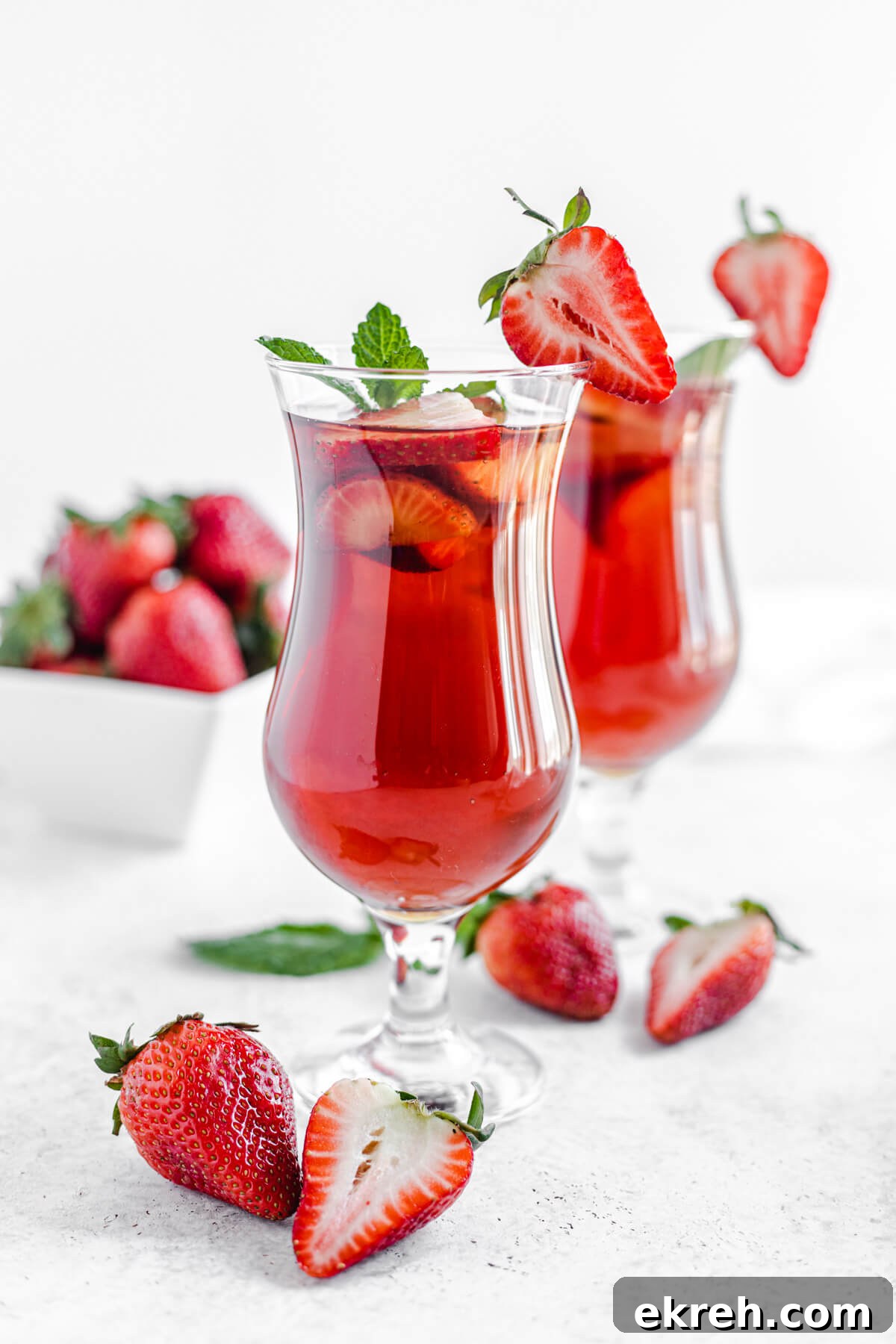 Homemade Strawberry Iced Tea Recipe 6 two glasses of iced tea with fresh mint and strawberries inside