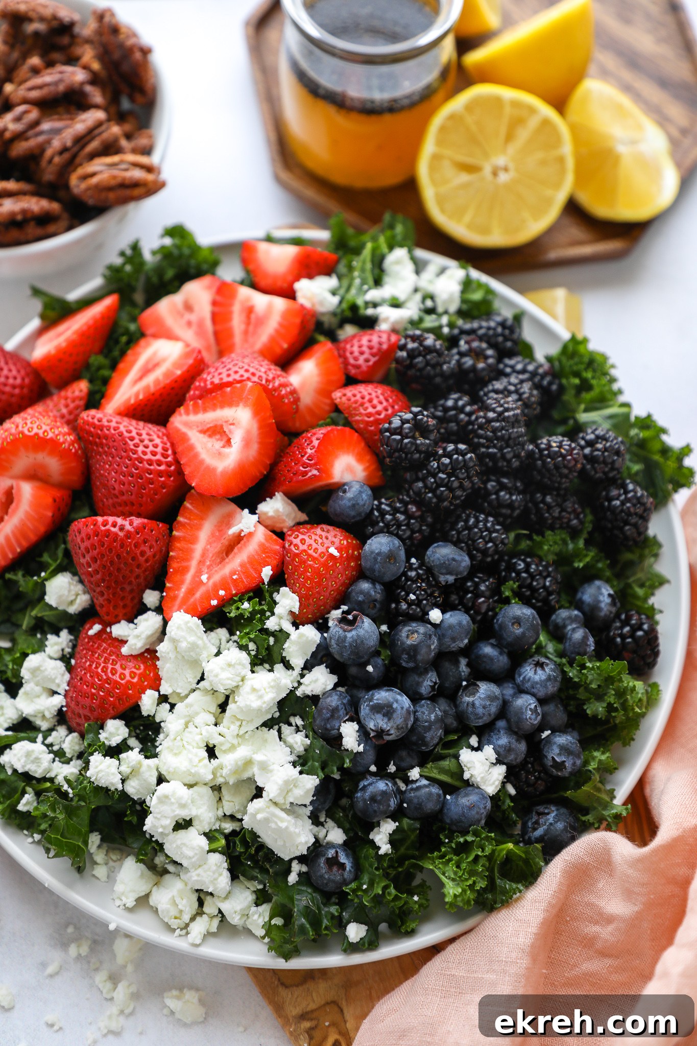 Kale Salad with Mixed Berries and Lemon Poppy Seed Dressing 3 A simple spring and summer salad made with fresh seasonal fruit, goat cheese and the best homemade candied pecans!