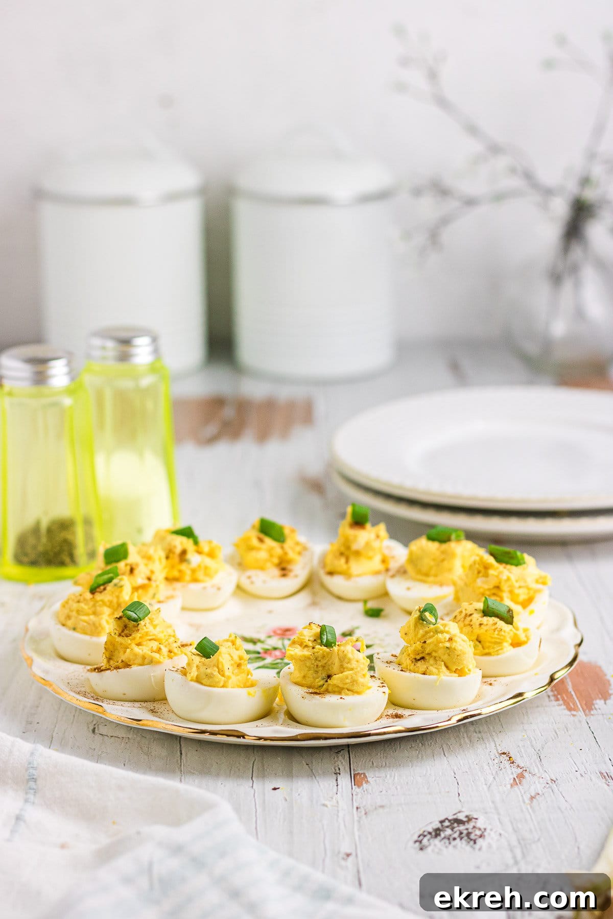 Creamy Ranch Deviled Eggs Recipe 8 Ranch deviled eggs topped with green onions on an egg platter.