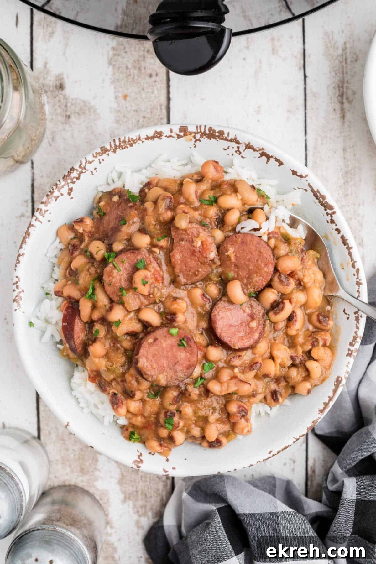 A bowl full of crock pot hoppin john on rice.