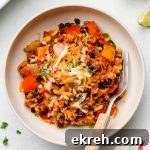 quinoa Mexican taco casserole in a white bowl with dairy free cheese on top