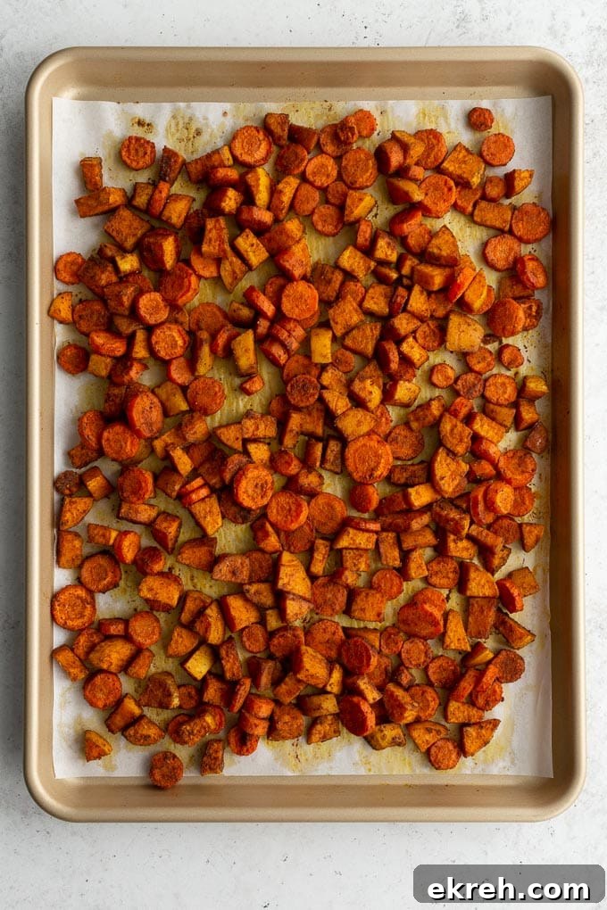 Creamy Roasted Sweet Potato and Carrot Soup Recipe 4 Chopped and roasted sweet potatoes and carrots on a sheet pan.