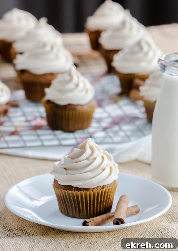 Cupcakes with delicious gingerbread spices. Topping this gingerbread classic flavor is a spiced buttercream frosting. Gingerbread Cupcakes topped with a spiced buttercream frosting on a white dessert plate with two cinnamon sticks.
