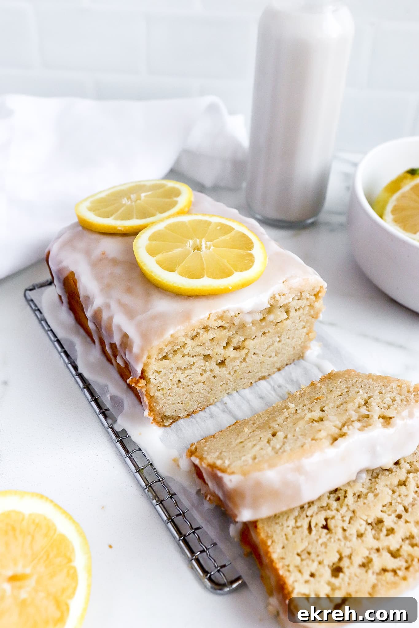 side angle of copycat starbucks lemon loaf cake with fresh lemon rings on top