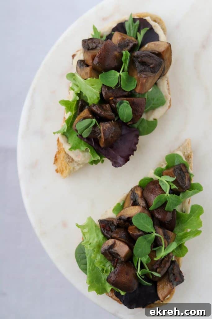 Balsamic-Glazed Mushroom Smorrebrod with White Bean Puree 7 Open sandwiches on a plate with lettuce and mushrooms