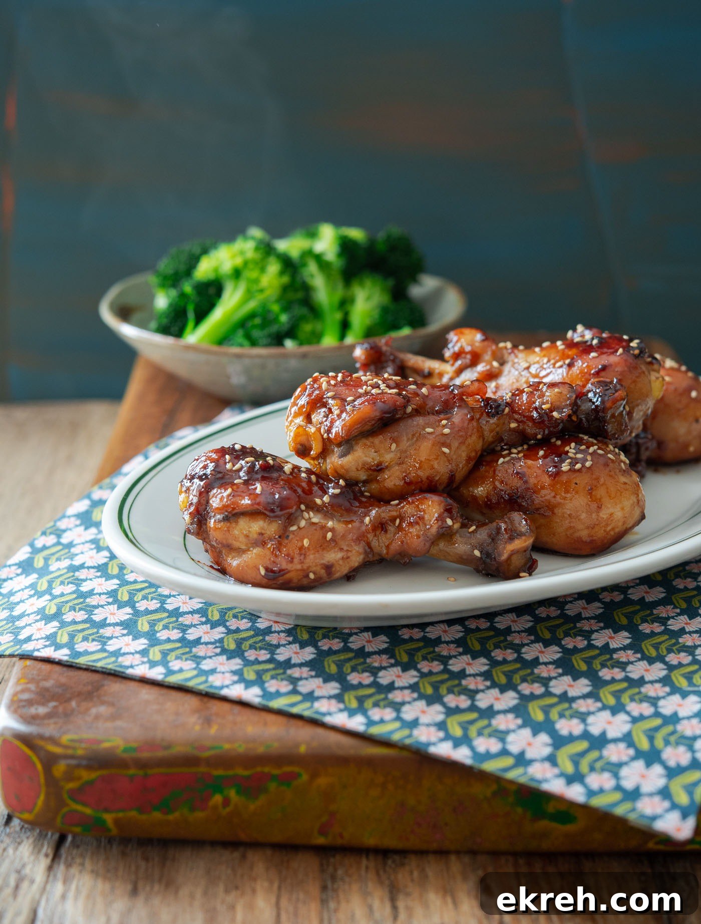 Stovetop teriyaki chicken drumsticks served with steamed broccoli.